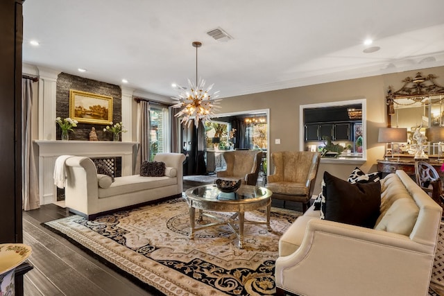 living room with a notable chandelier, crown molding, and dark wood-type flooring