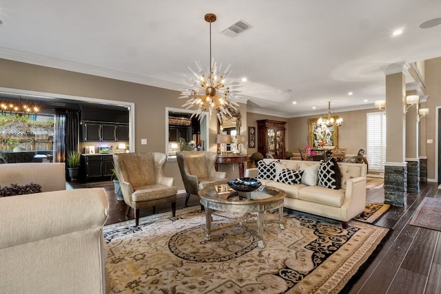 living room with crown molding, dark hardwood / wood-style floors, and an inviting chandelier