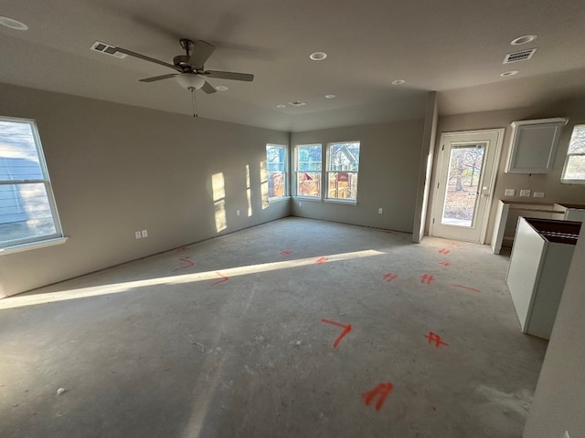 unfurnished living room featuring ceiling fan