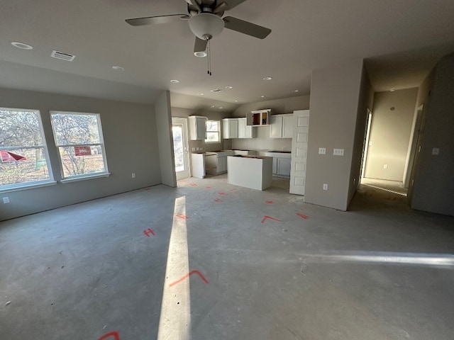 unfurnished living room featuring ceiling fan and vaulted ceiling