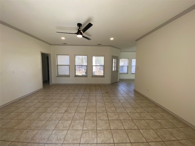 tiled empty room with ceiling fan and crown molding