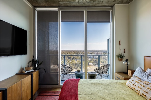 bedroom featuring hardwood / wood-style floors and a wall of windows