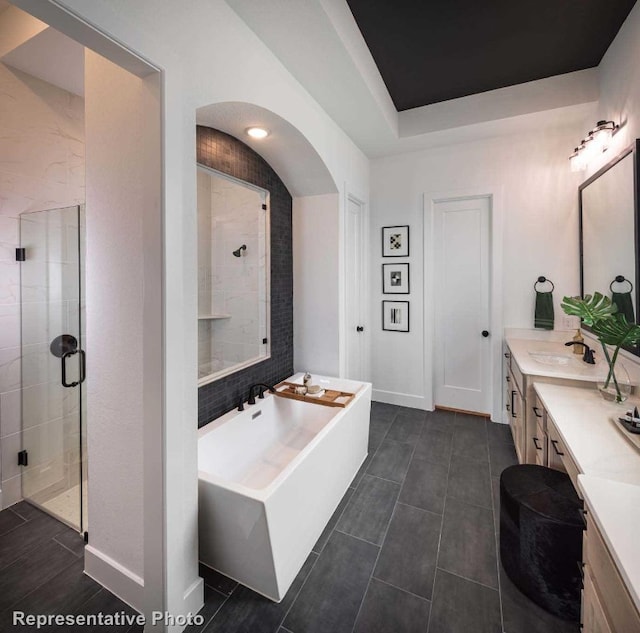 bathroom featuring tile patterned flooring, vanity, and plus walk in shower