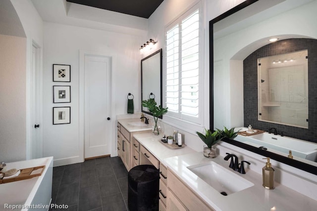 bathroom with a shower, plenty of natural light, vanity, and tile patterned flooring