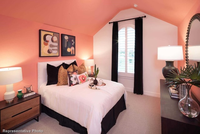 bedroom with light carpet and vaulted ceiling