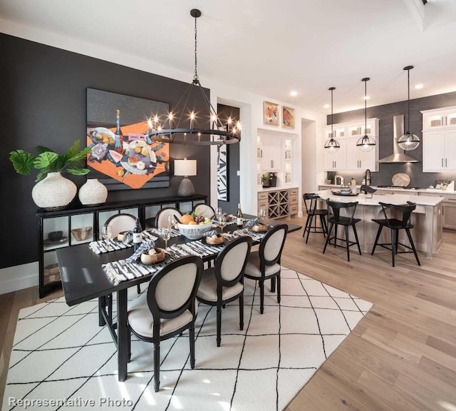 dining area featuring light wood-type flooring and a chandelier