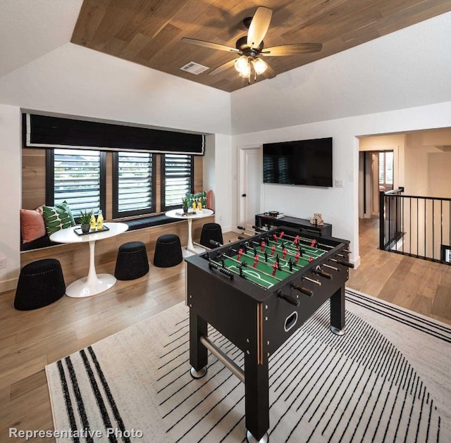 rec room with wooden ceiling, ceiling fan, wood-type flooring, and vaulted ceiling