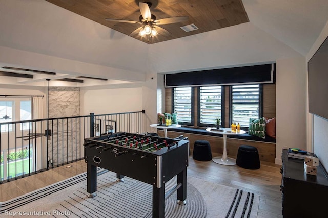 rec room featuring ceiling fan, wood-type flooring, and vaulted ceiling