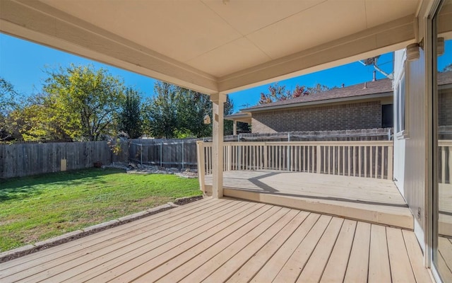 wooden terrace with a lawn