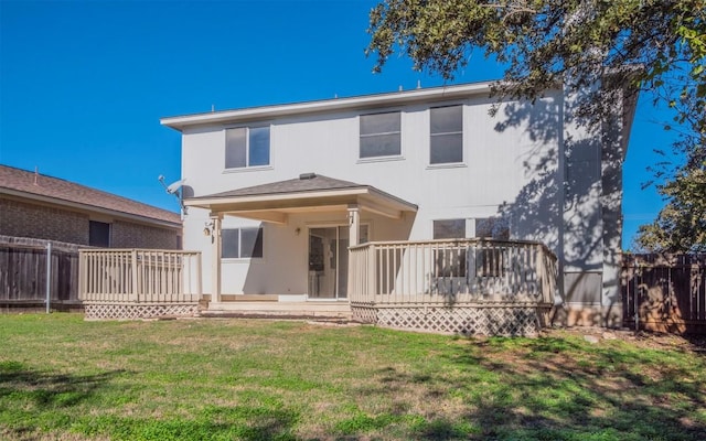 back of house with a yard and a wooden deck