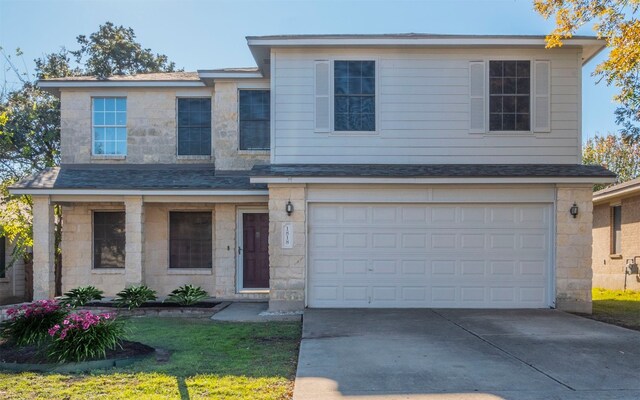 view of front of house with a garage and a front lawn