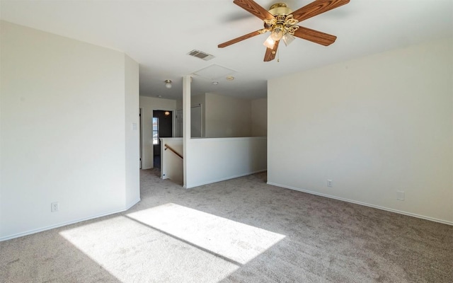 spare room with ceiling fan and light carpet