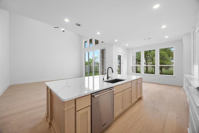 kitchen featuring a sink, light wood-style flooring, a wealth of natural light, and dishwasher