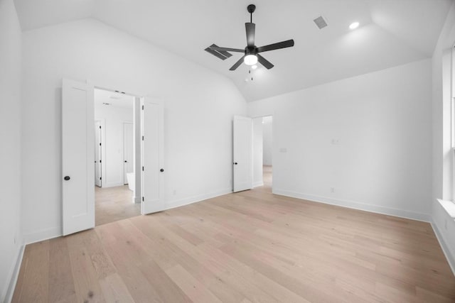 unfurnished bedroom with baseboards, vaulted ceiling, light wood-style flooring, a ceiling fan, and visible vents