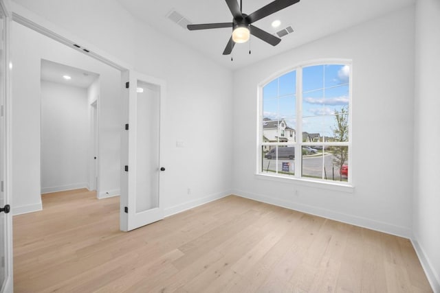 interior space with light wood finished floors, baseboards, and visible vents