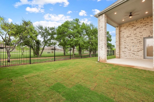 view of yard with a patio area, fence, and a ceiling fan