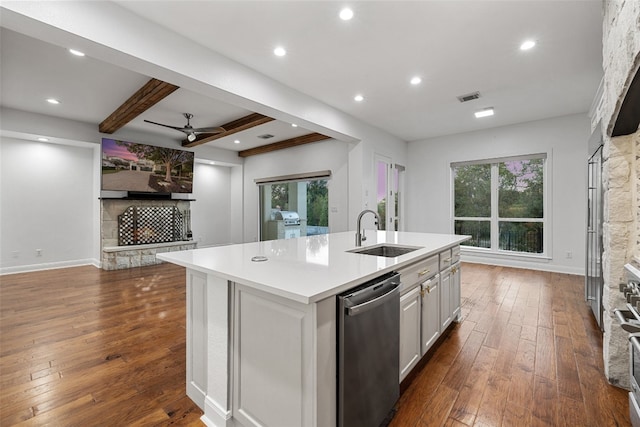 kitchen featuring dishwasher, dark wood-type flooring, a center island with sink, white cabinets, and sink