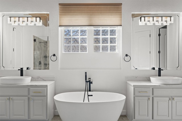 bathroom featuring vanity and shower with separate bathtub