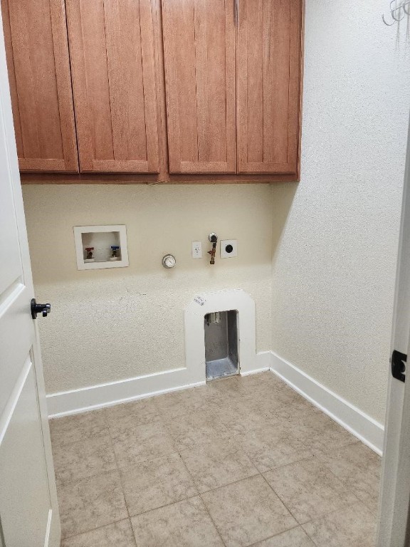 washroom featuring hookup for an electric dryer, hookup for a gas dryer, cabinets, and washer hookup