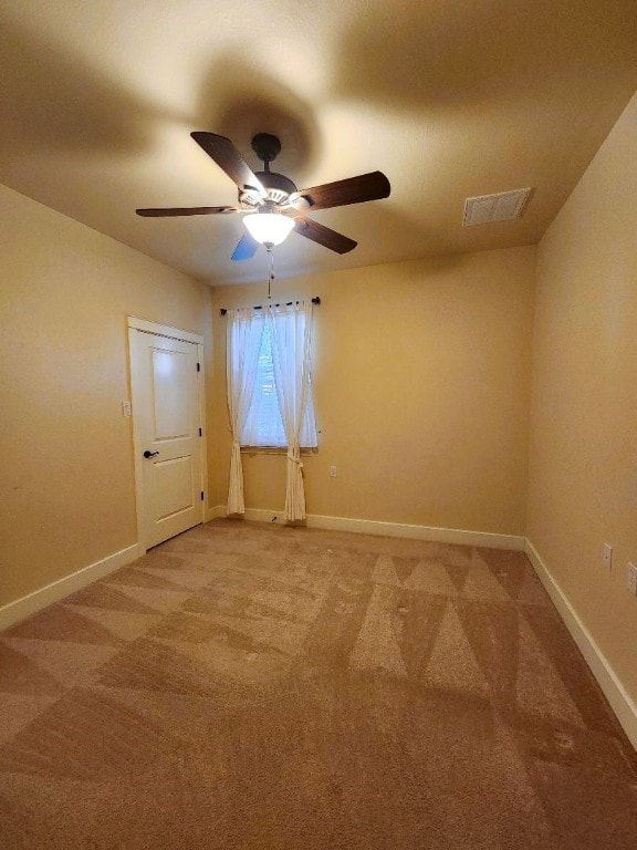 spare room with carpet and ceiling fan