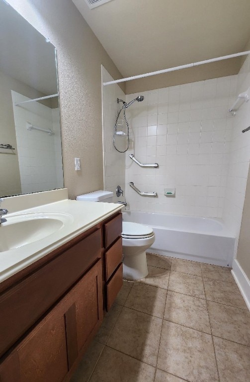 full bathroom with tile patterned floors, vanity, toilet, and tiled shower / bath combo