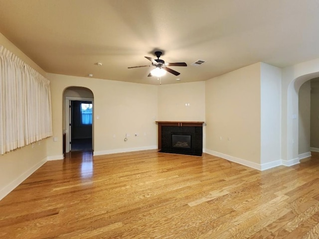 unfurnished living room with light hardwood / wood-style flooring and ceiling fan