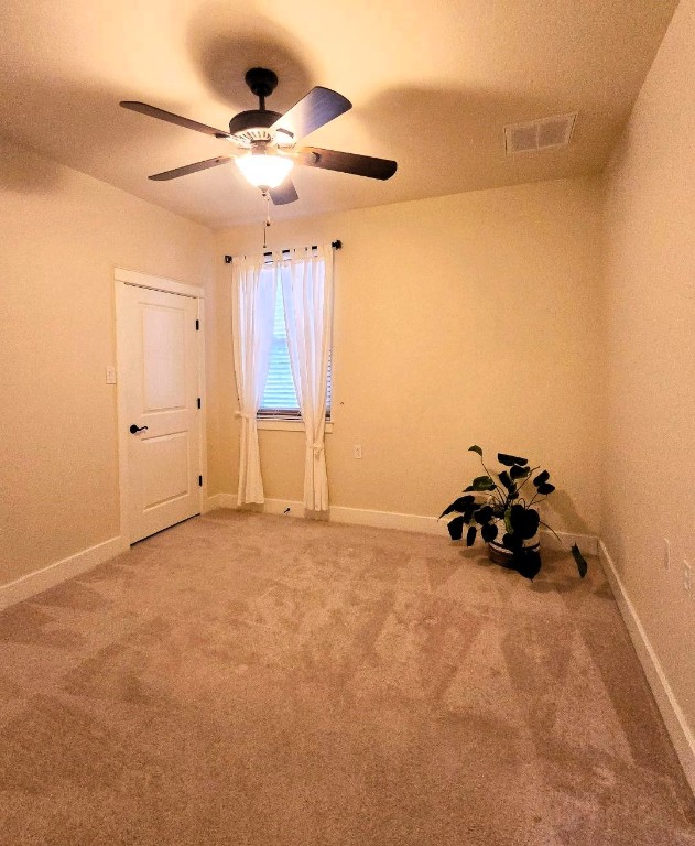 interior space featuring carpet floors, visible vents, and baseboards