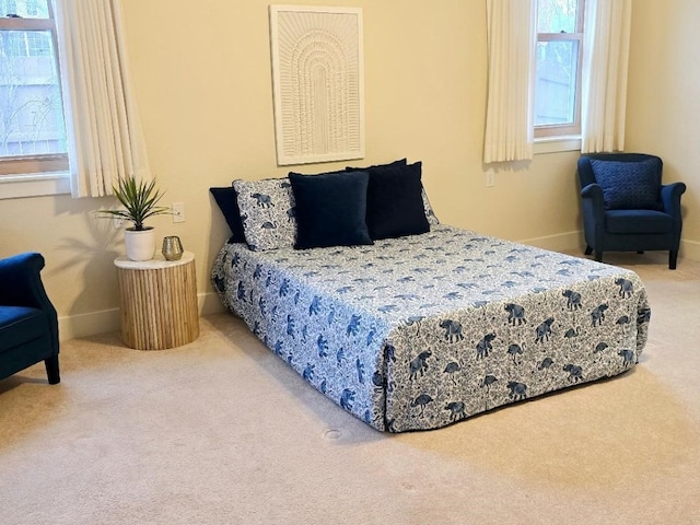 carpeted bedroom featuring baseboards