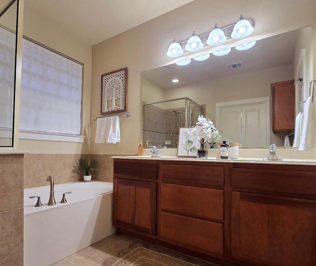 full bath with double vanity, visible vents, a garden tub, a shower stall, and a sink