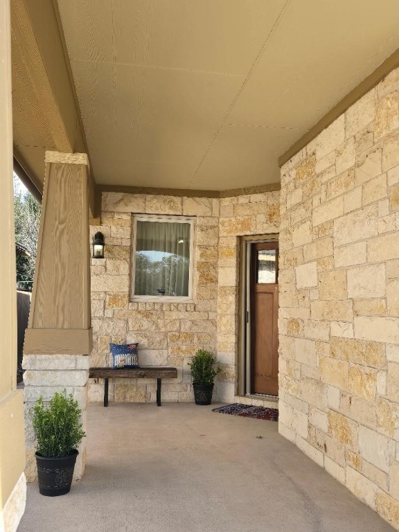 property entrance with stone siding