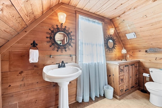 bathroom with wood ceiling, lofted ceiling, tile patterned floors, and wooden walls