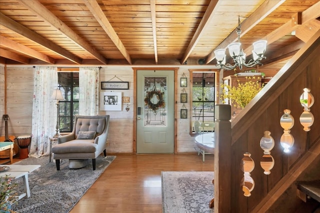 entryway featuring hardwood / wood-style floors, a healthy amount of sunlight, wooden ceiling, and wooden walls