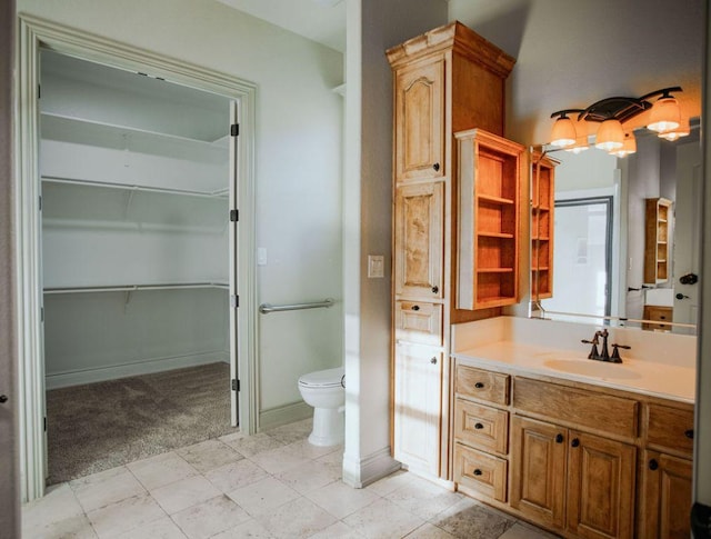 full bath featuring baseboards, toilet, a spacious closet, and vanity