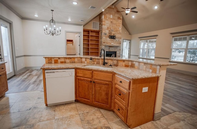 kitchen featuring a sink, a center island with sink, open floor plan, and dishwasher