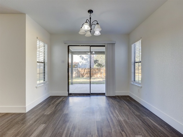 unfurnished dining area with a wealth of natural light and dark hardwood / wood-style flooring