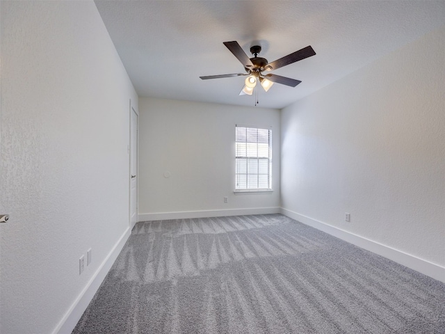 spare room with ceiling fan and carpet floors