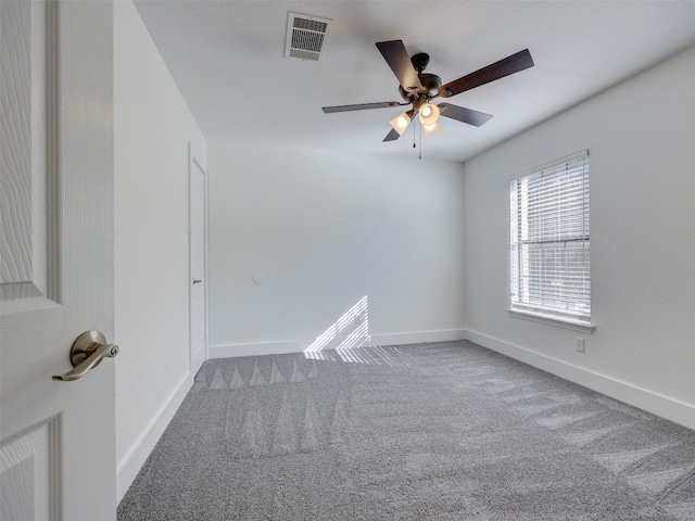 carpeted empty room featuring ceiling fan