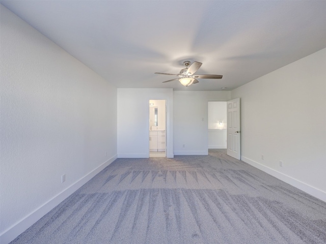 spare room featuring light colored carpet and ceiling fan