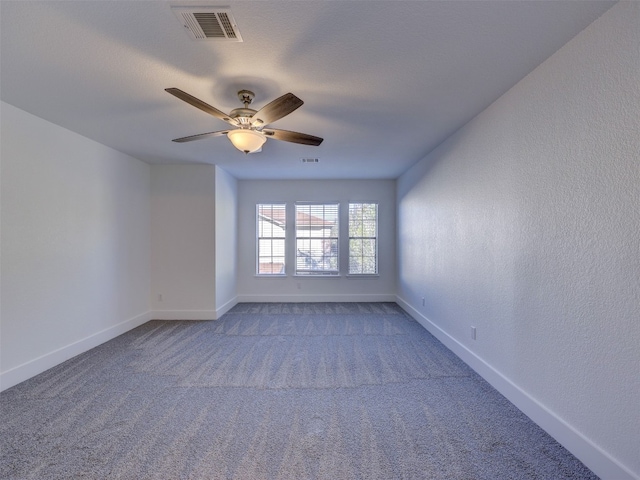 carpeted spare room featuring ceiling fan