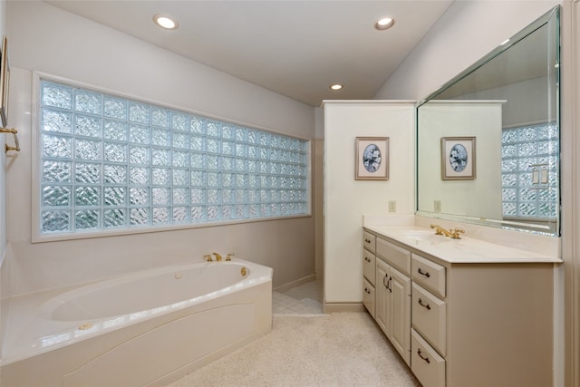 bathroom featuring vanity, a bathtub, and a healthy amount of sunlight