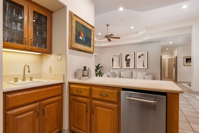 kitchen featuring kitchen peninsula, ceiling fan, sink, and light tile patterned flooring