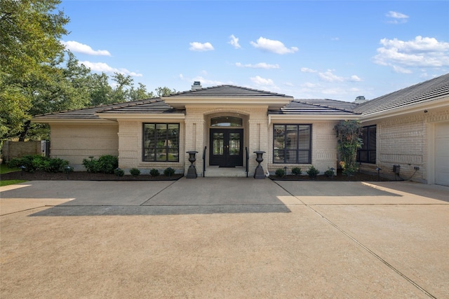 view of front of house featuring a garage and french doors