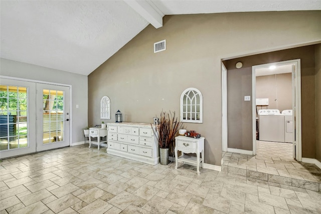 interior space featuring washer and dryer, beam ceiling, and high vaulted ceiling