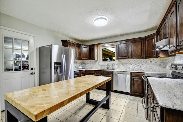 kitchen with dark brown cabinets, sink, a textured ceiling, and appliances with stainless steel finishes