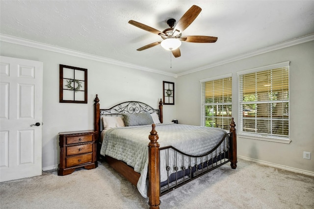 bedroom with ceiling fan, light colored carpet, ornamental molding, and a textured ceiling