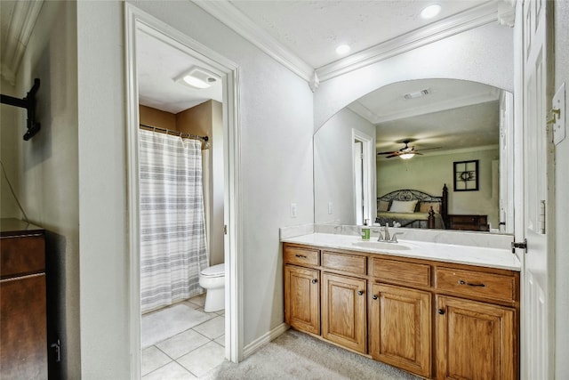 bathroom featuring vanity, tile patterned floors, ceiling fan, toilet, and ornamental molding