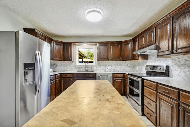 kitchen featuring dark brown cabinets and appliances with stainless steel finishes