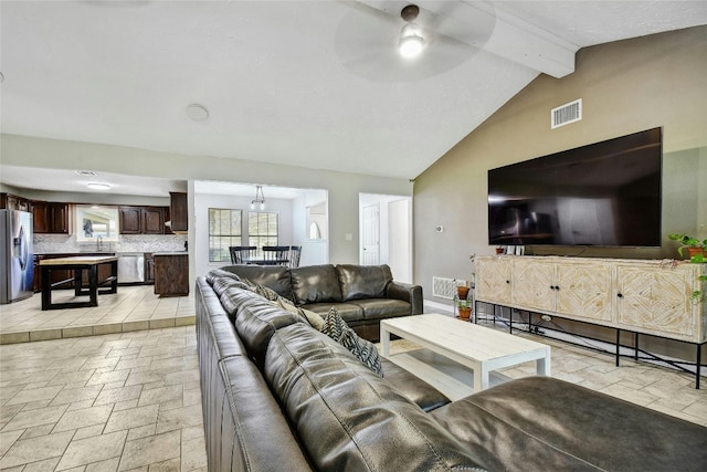 living room featuring ceiling fan, beam ceiling, sink, and high vaulted ceiling