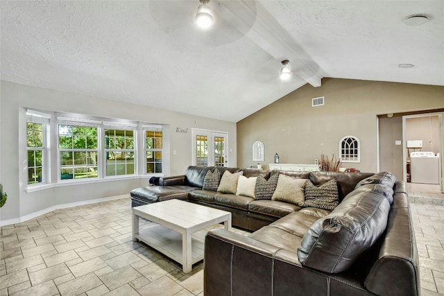 living room with a textured ceiling, lofted ceiling with beams, washer / clothes dryer, and ceiling fan