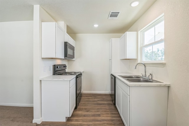 kitchen featuring black appliances, dark hardwood / wood-style floors, white cabinets, and sink